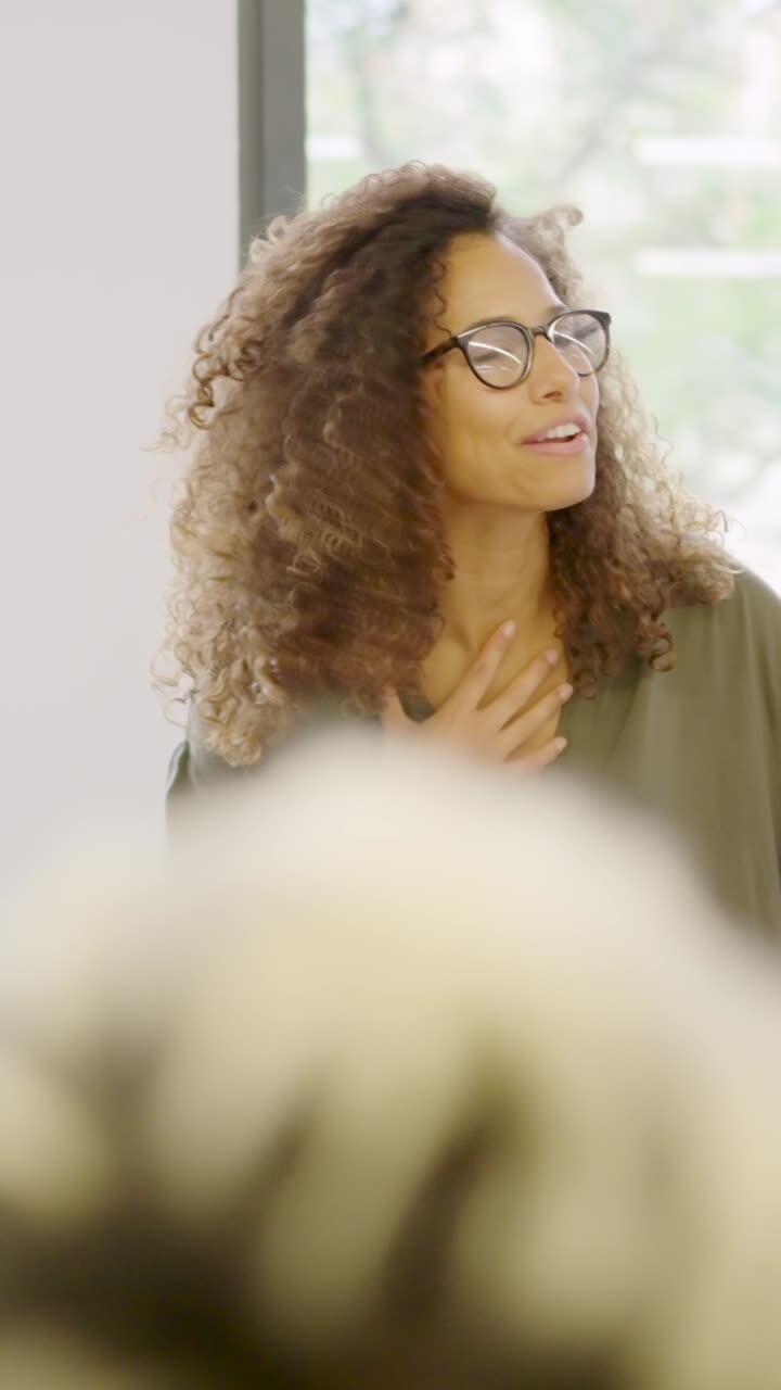 Manager congratulating colleagues in a coworking office
