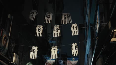 Alleyway-Football-Jerseys-Display-in-Naples,-Italy-at-night