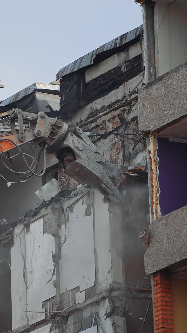 Demolition building after nature disease. Urban excavator destruction demolishing. Vertical video
