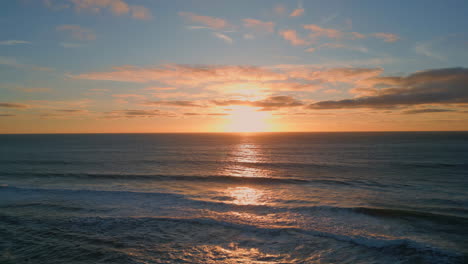 puesta de sol mar ondulante agua playa vista aérea. amanecer dorado cielo oscuro océano sereno