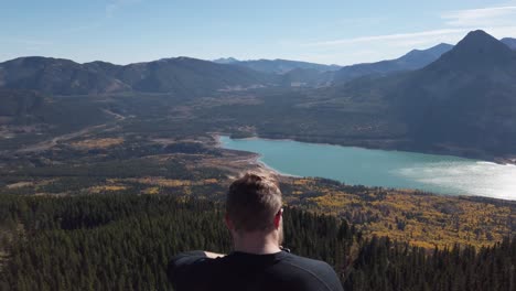 hiker relaxing on peak at barrier lake kananaskis alberta static