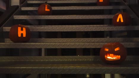 halloween pumpkins on metal stairs spelling out 'halloween'