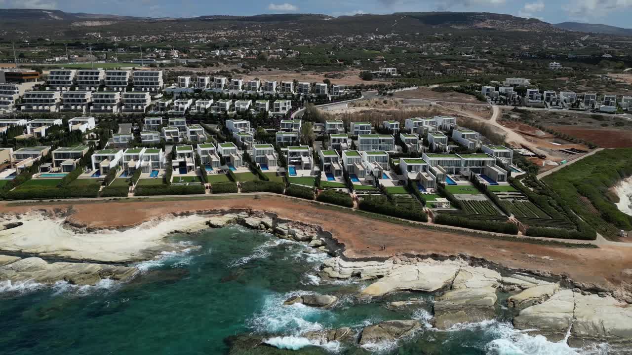 Elegant terrace homes overlook the blue seafront, embodying luxury beachside living with breathtaking ocean views, offering an exclusive blend of style, comfort, and tranquility.