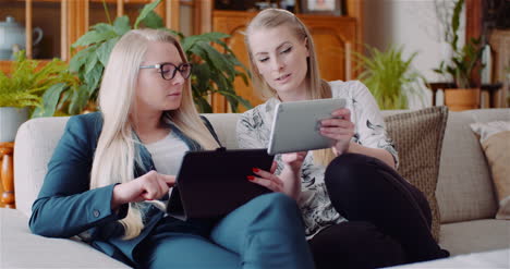 businesswomen discussing over technologies in office businesswomen working on digital tablet 6