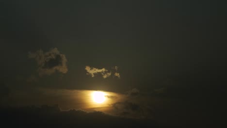 The-beautiful-yellow-sun-setting-behind-the-clouds---time-lapse