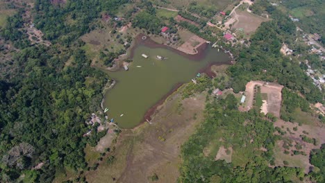 Hypnotizing-zoom-in,-4k-aerial-view-looking-into-the-famous-and-touristy-Laguna-de-los-Milagros-located-in-the-tropical-rain-forest-area-of-Tingo-Maria,-Amazon,-Peru