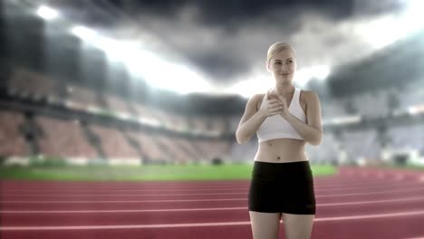 Female-athlete-clapping-hands-in-stadium