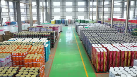 atmospheric canning massive warehouse distribution facility with colorful product boxes workshop production with stacked cans, pallets of goods in busy industrial food manufacturing and transportation