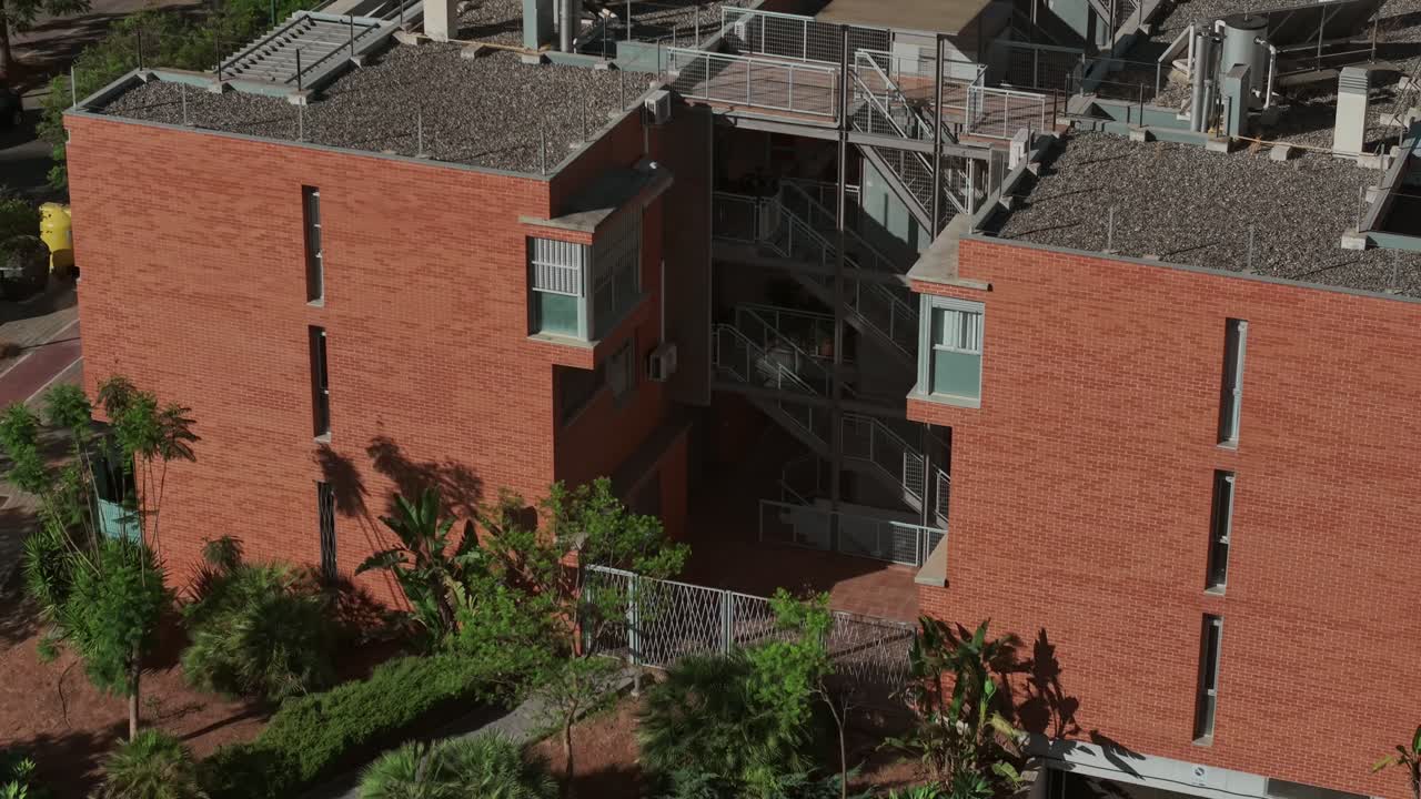 Aerial view of Soliva Este modern red brick apartment buildings with balconies in urban setting, Málaga, Spain