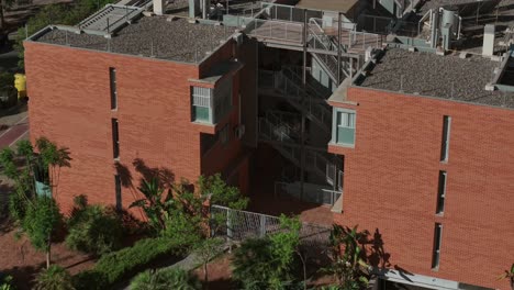 aerial view of soliva este modern red brick apartment buildings with balconies in urban setting, málaga, spain