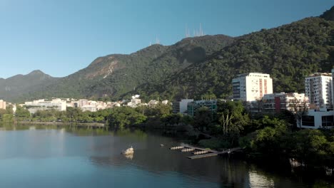 sideways aerial movement showing the rowing practice pier with the corcovado mountain in rio de janeiro behind seen from the city lake at sunrise