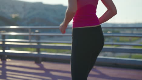 woman running on a city bridge