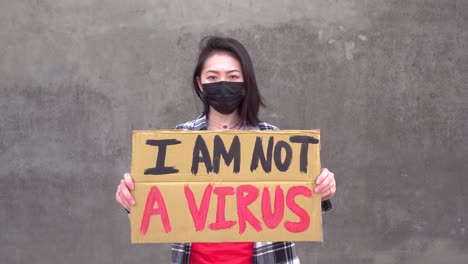 asian woman with poster during protest against sexual harassment