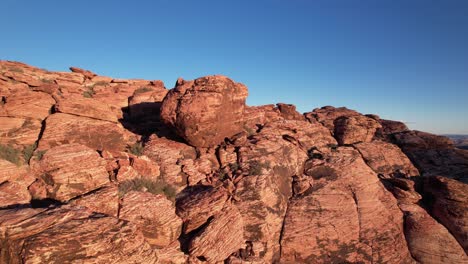 drone close up of red rock formation in california las vegas, aerial of detailed erosion pattern
