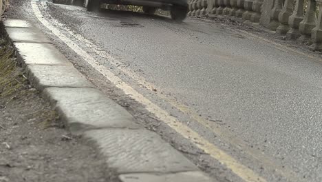 Cars-driving-over-countryside-bridge