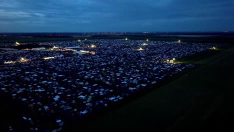 Nighttime-View-Of-Nova-Rock-Festival-In-Pannonia-Fields-II,-Nickelsdorf,-Austria---aerial-drone-shot