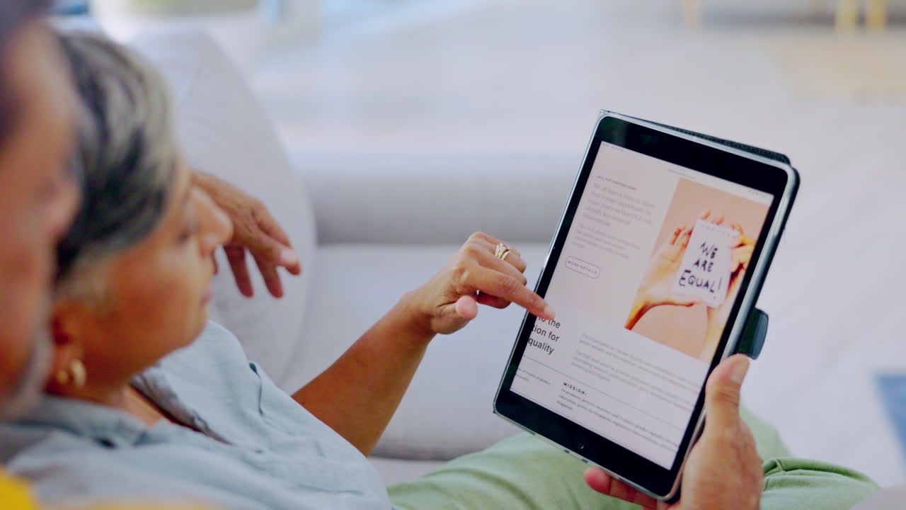 Hands, tablet and couple on sofa with reading