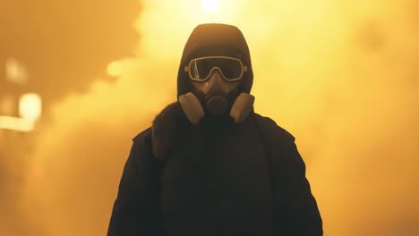 person in gas mask amidst smoke