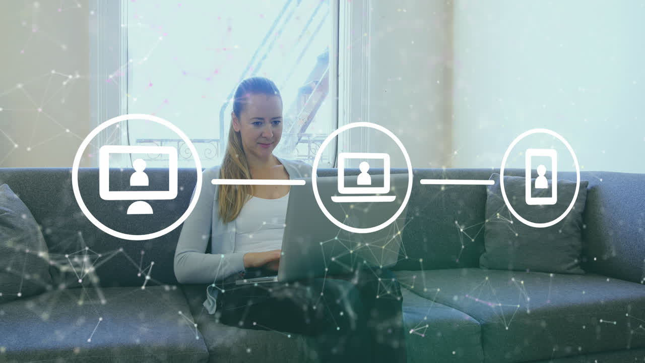 Animation of connected icons and dots over caucasian woman sitting on sofa and working on laptop