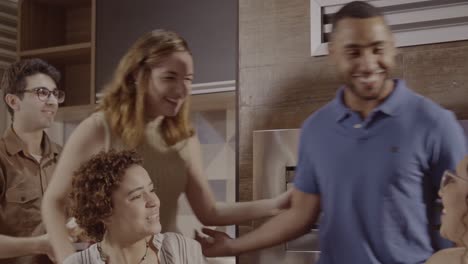 people gathering and socializing in a kitchen