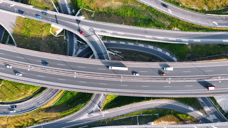 complicated system of roads with multiple cars moving by. traffic in the countryside of slovakia. top view