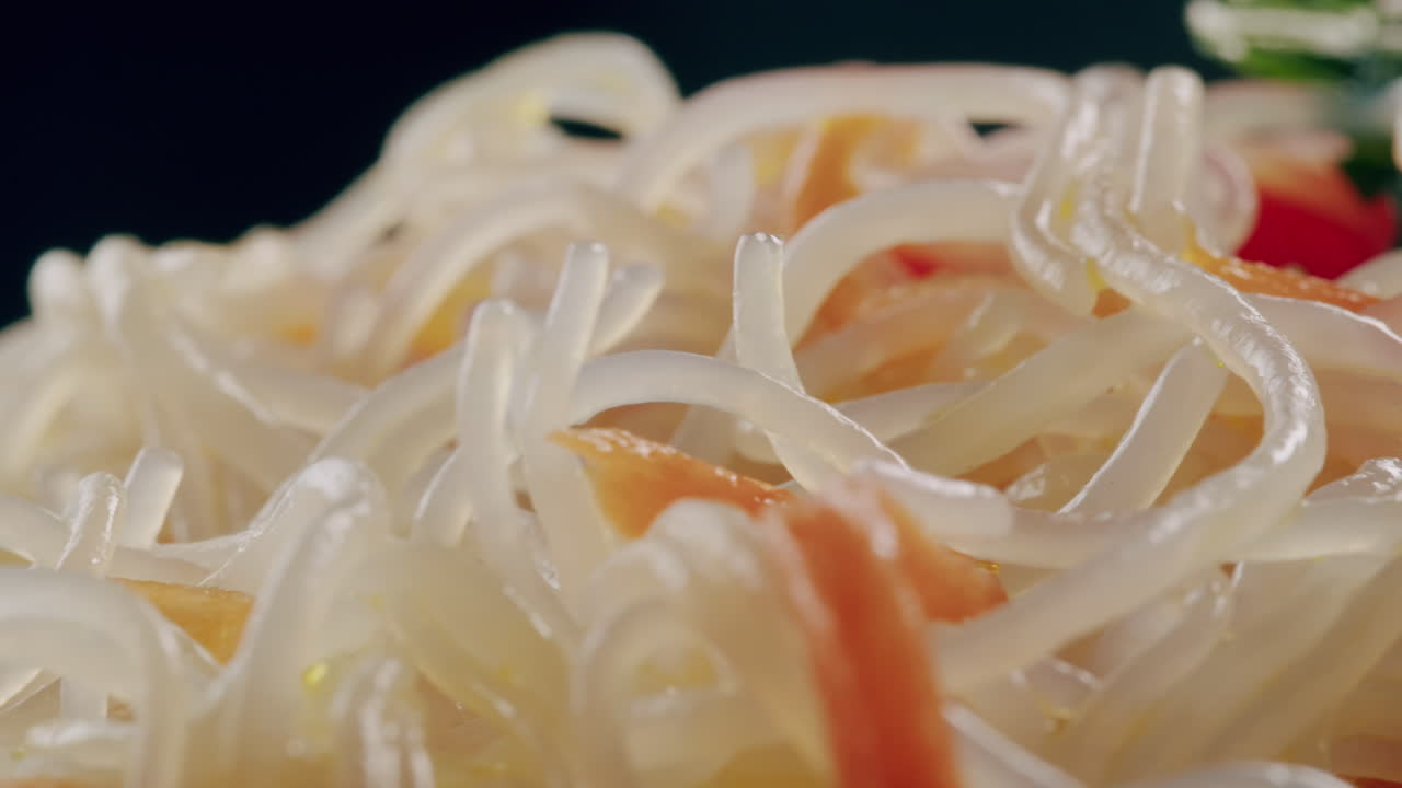 Glass noodles salad with meat and carrots fermented close up asian chinese traditional food.