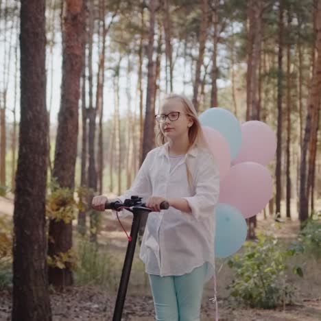 A-child-on-a-scooter-decorated-with-balloons-rides-through-the-park