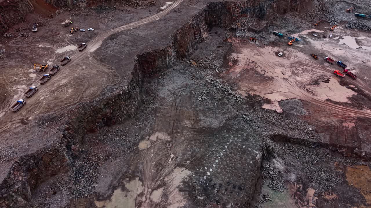 Granite extraction process at an industrial quarry in a rocky area