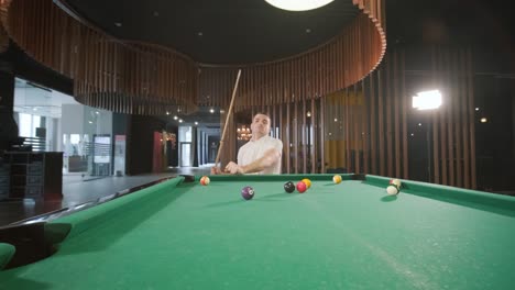 adult men with disabilities in a wheelchair play billiards in the club