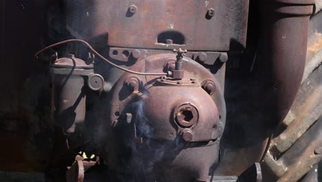 old locomotive releasing steam and smoke