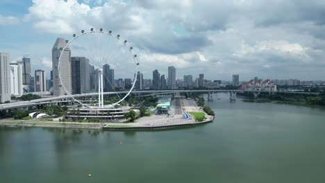 drone shot of marina promenade and singapore flyer eye, camera orbiting around marina bay f1 track