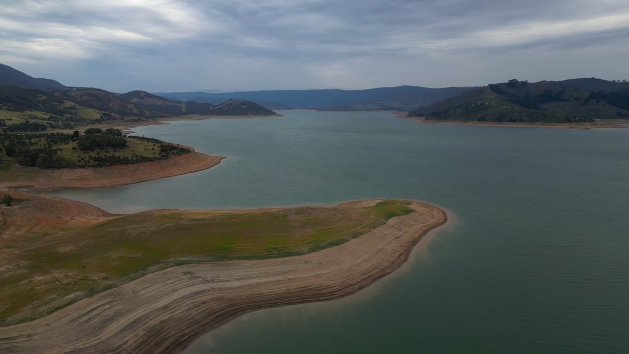 Right to left aerial view over Blowering Reservoir (dam) near Tumut in the Snowy Mountains Region of New South Wales.