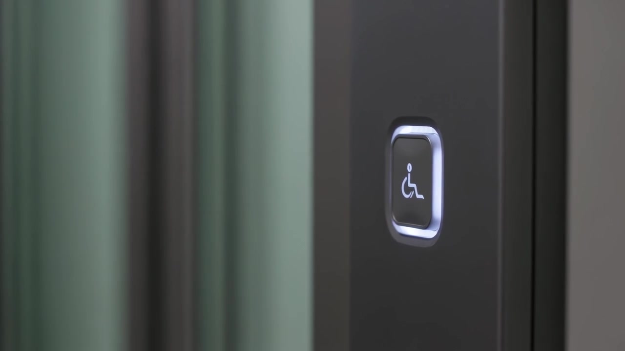 Approaching right finger pressing wheelchair button on panel by doors, calling elevator, copy space