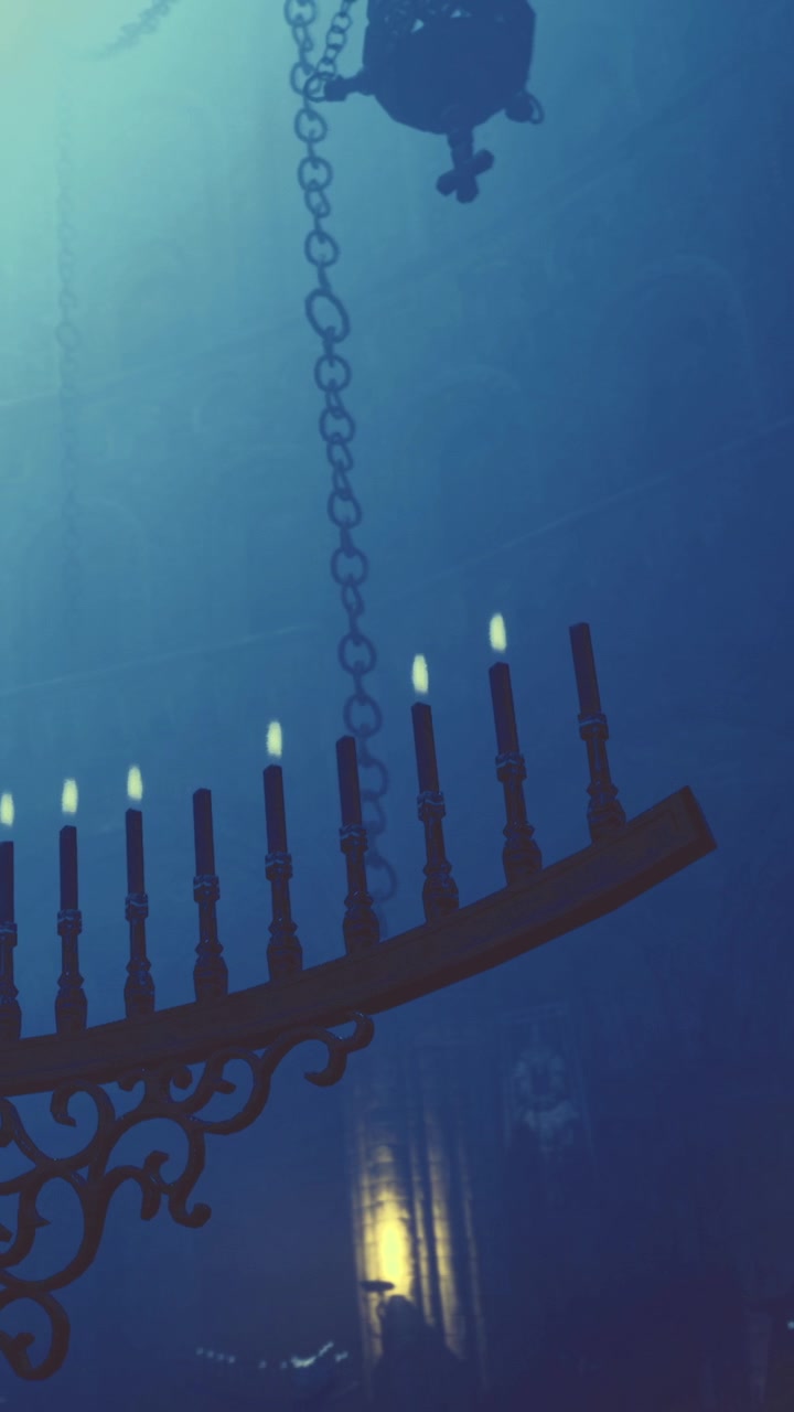 Chandelier hangs from the ceiling in a dimly lit room late at night