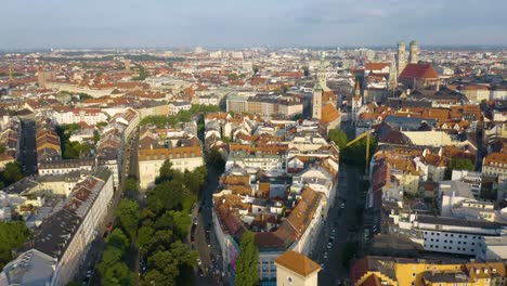 drone flies over munich's old town on beautiful summer day