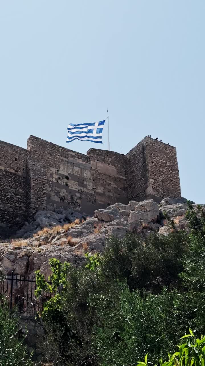 Greek Flag Flying Over the Acropolis in Athens
