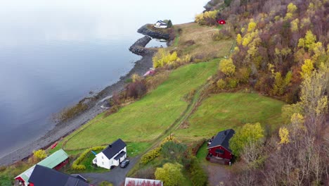 typical autumn countryside landscape with norwegian houses by the shore of fjord in norway