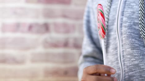 child holding a lollipop