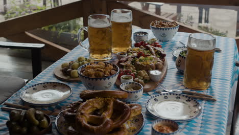 Oktoberfest feast with beer and pretzels on a wooden table