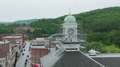 aerial telephoto view: men working on clocktower with scaffolding