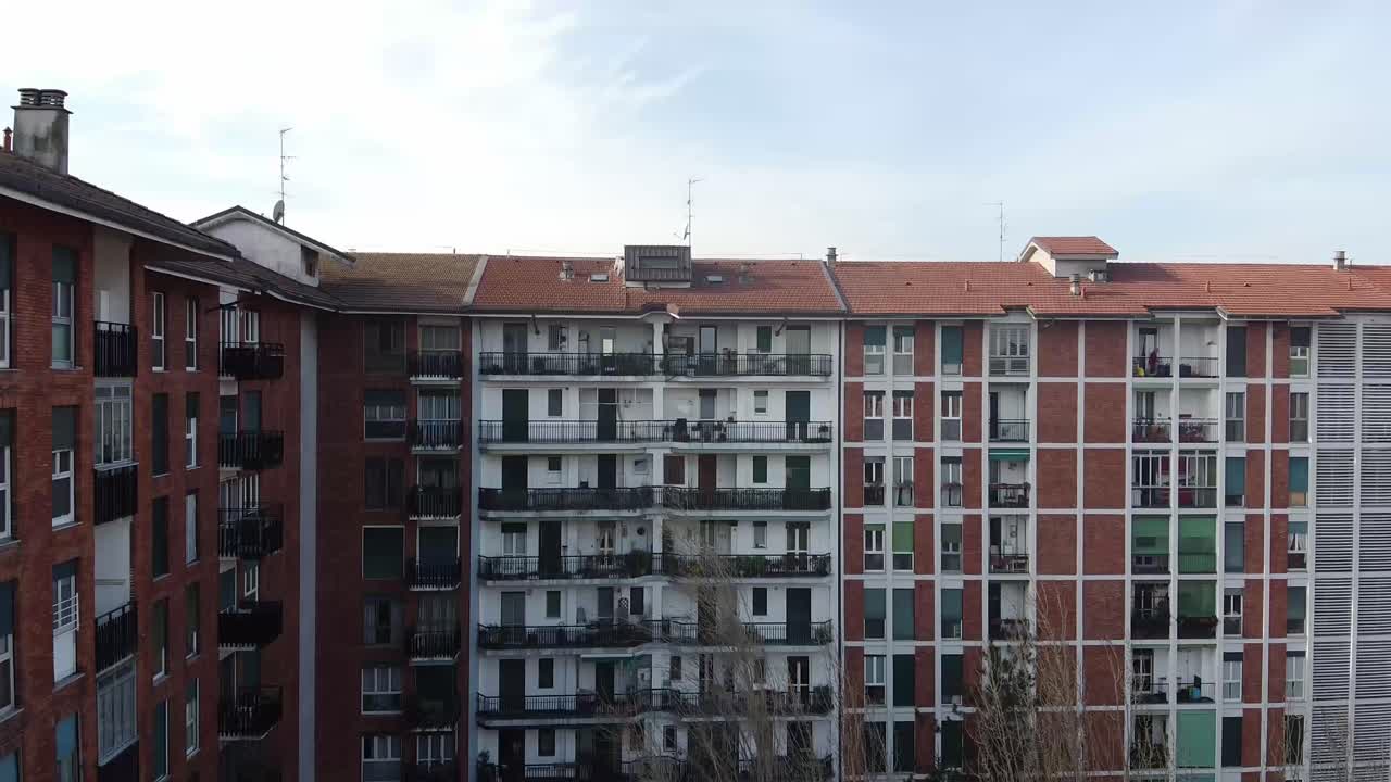 Ascend above apartment building and reveal of Milan skyline