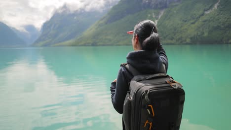 hiking woman walk with a hiking backpack in beautiful nature of norway.