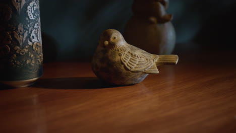 figure of wood bird on table indoors. animal sculpture for interior decoration.