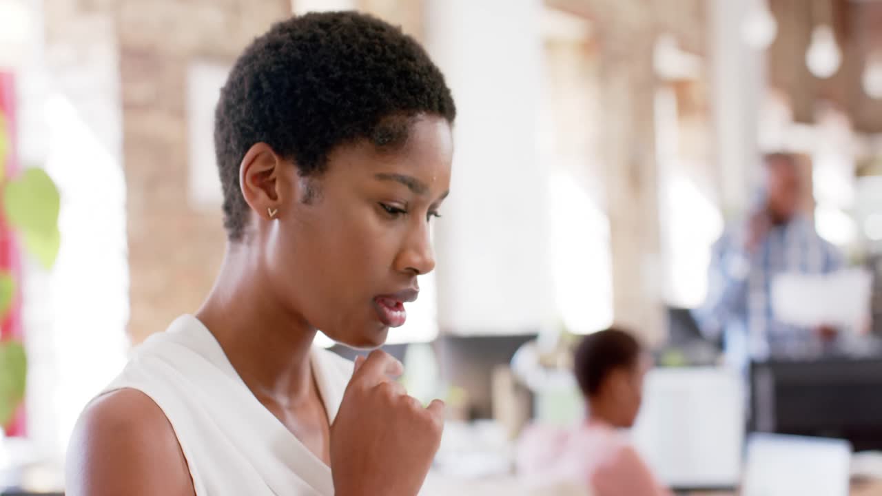 Portrait of happy african american colleagues working in creative office in slow motion