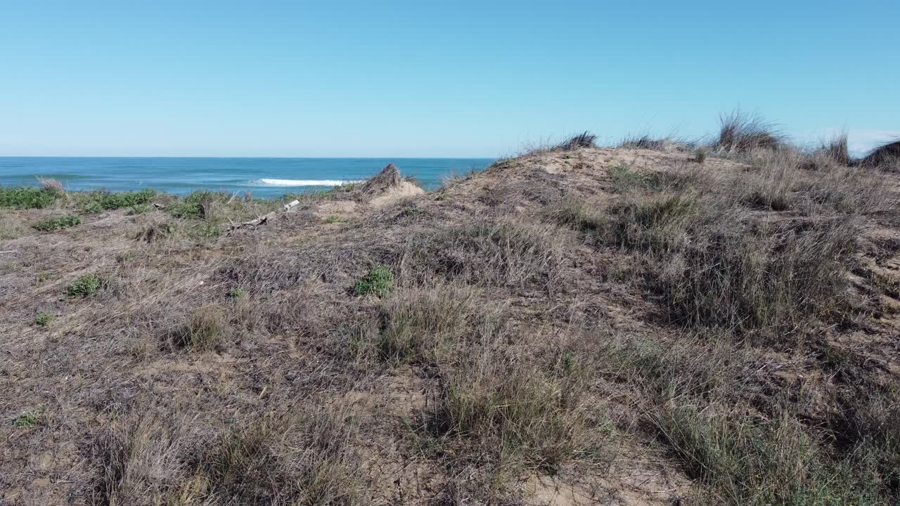 4K Low-Altitude Drone Flight Over Dune with Mediterranean Sea, Breaking Waves, and Cargo Ship in Spain