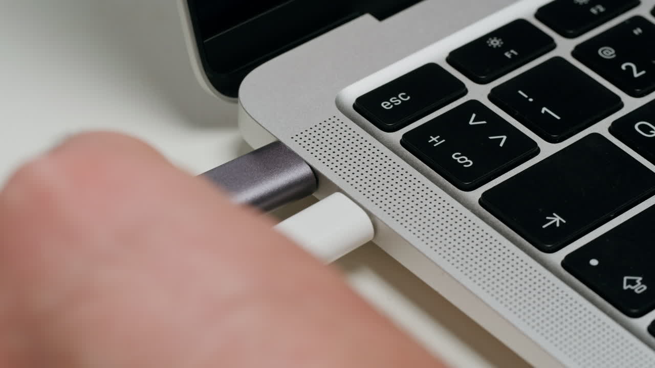 Hand Connecting Cable to Laptop USB-C Port
