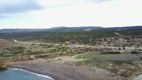 wide aerial drone shot of the akamas peninsula of cyprus in paphos with mountain range, cliffs, valleys and coastline