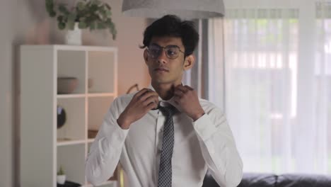 medium closeup of young indian intern getting dressed for first day of work