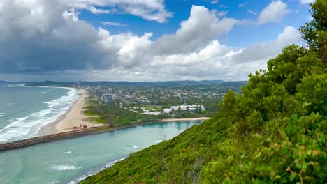 Burleigh-Heads,-Gold-Coast-with-Tallebudgera-Beach-and-Creek---looking-down-from-rainforest-lookout-down-to-coast-over-river-inlet-with-puffy-clouds
