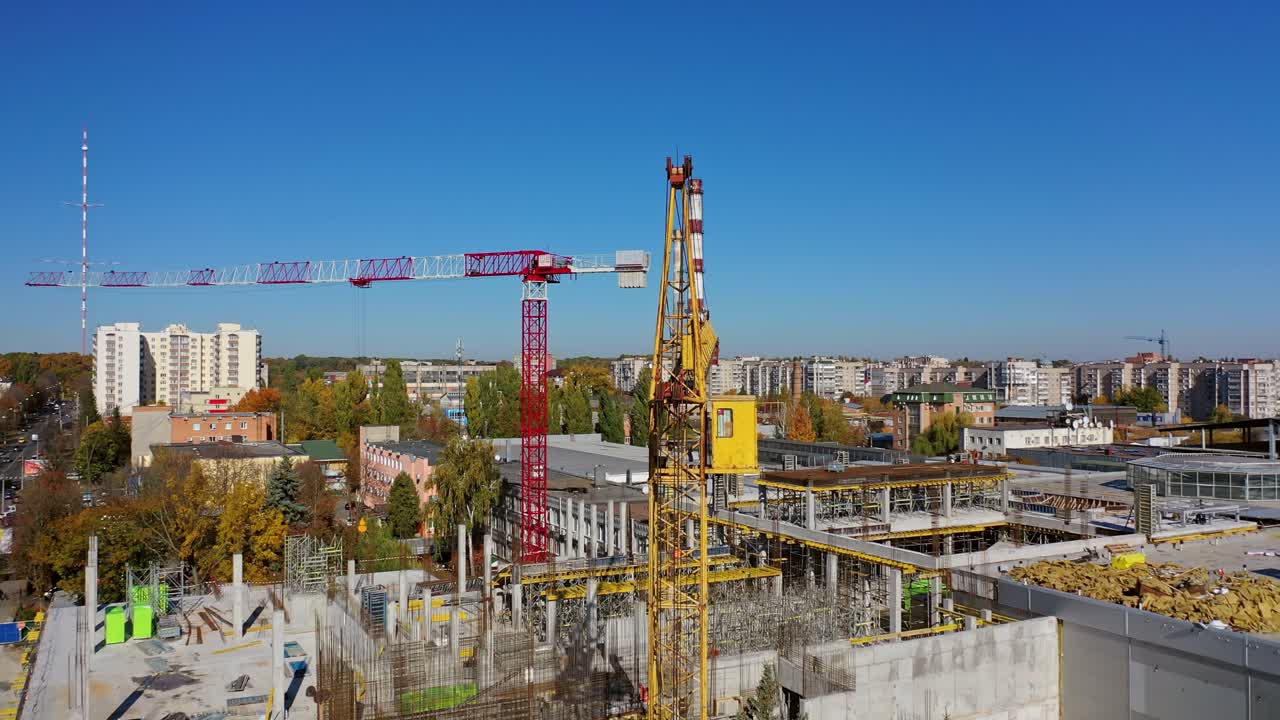 Construction site with a bird's eye in a megacity. Video shooting with drone. New office in a new residential complex. Aerial view.